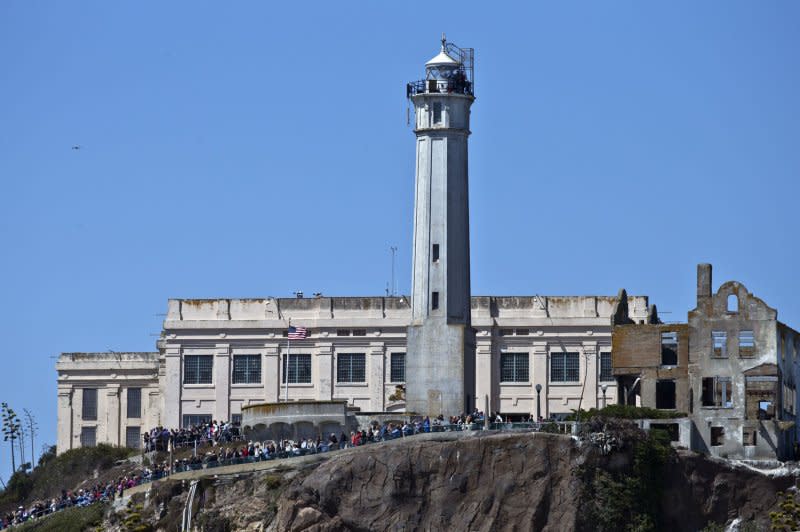 Spectators line the walls of Alcatraz Island to watch Emirates New Zealand take on defender Oracle Team USA in race eight of the America's Cup series on San Francisco on September 14, 2013. On March 21, 1963, the U.S. prison on San Francisco Bay's Alcatraz Island was closed. File Photo by Terry Schmitt/UPI