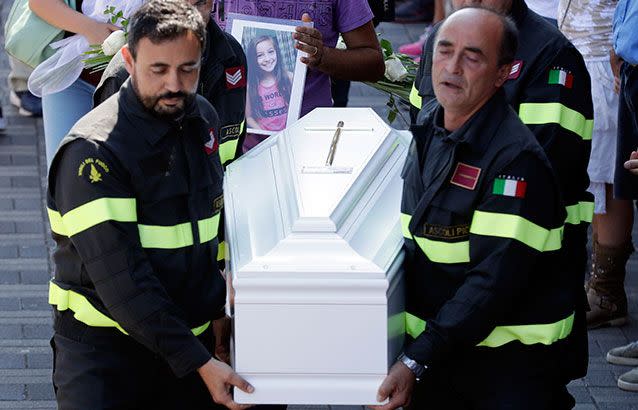 'Goodbye little one': The coffin of Giulia, 9 years old, is carried outside the gymnasium at the end of the state funeral service in Ascoli Piceno