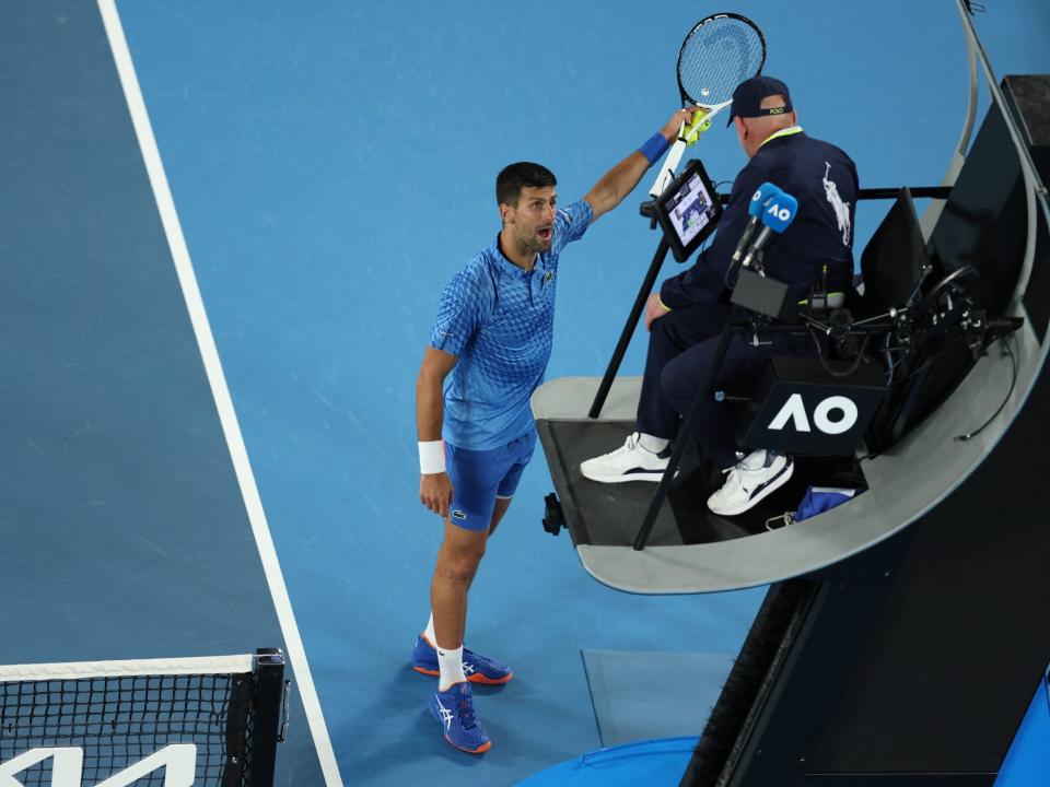 Novak Djokovic points out a heckler in the crowd at the 2023 Australian Open.