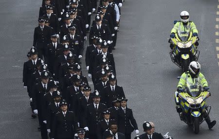 Police officers arrive near Southwark Cathedral ahead of the funeral of PC Keith Palmer, who was killed in the recent Westminster attack, in central London, Britain April 10, 2017. REUTERS/Hannah McKay