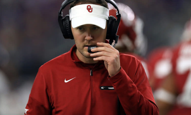 A closeup of Oklahoma Sooners coach Lincoln Riley talking into his headset.