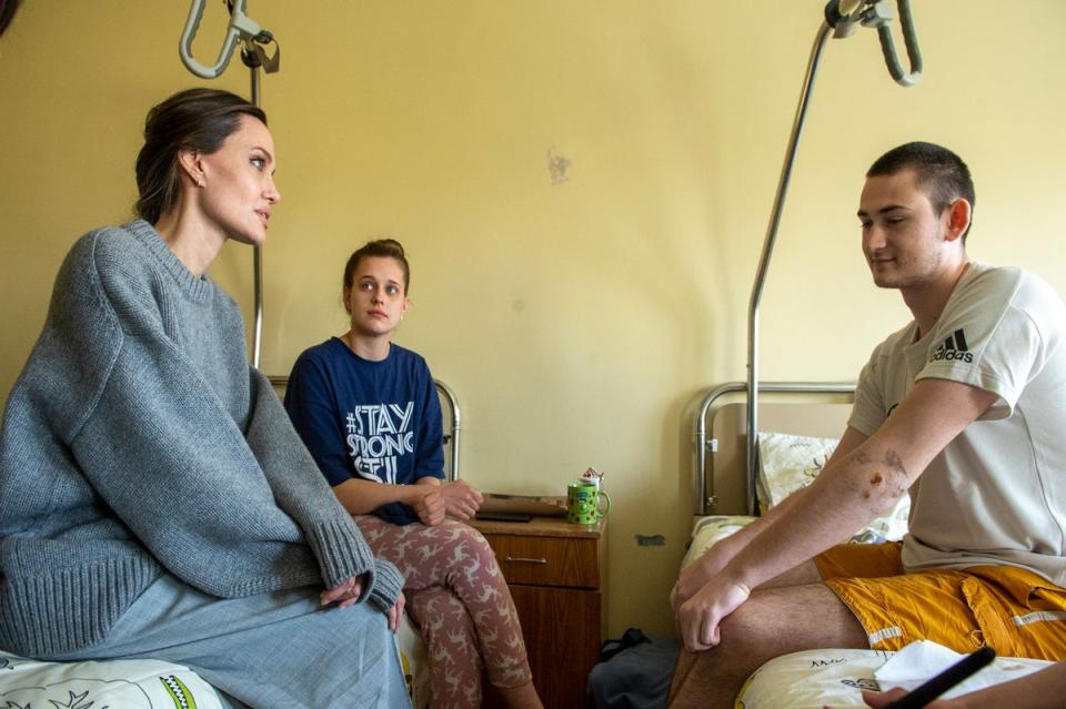 Angelina Jolie comforts a young victim of the Kramatorsk railway attack in Lviv (Handout)