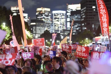 Protesters gather at a rally against Japan's Prime Minister Shinzo Abe's security bill and his administration in front of the parliament building in Tokyo, in this photo taken by Kyodo September 14, 2015. Mandatory credit REUTERS/Kyodo