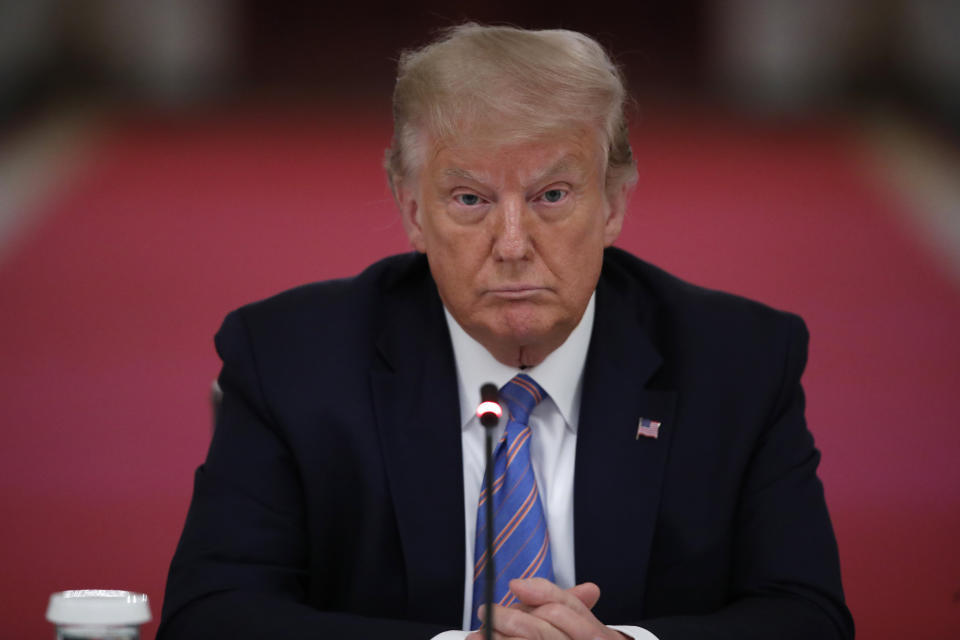 President Donald Trump listens during a "National Dialogue on Safely Reopening America's Schools" at the White House on Tuesday. He has said he will pressure states and local governments to open schools in the fall.  (Photo: ASSOCIATED PRESS)