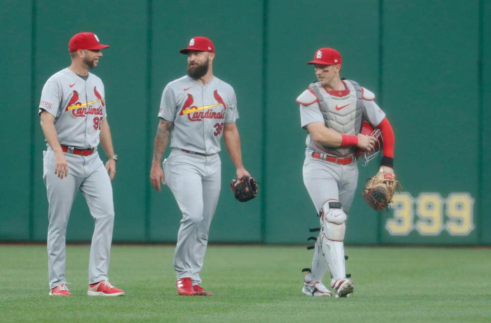 St. Louis Cardinals pitching coach Dusty Blake (90) and starting pitcher Drew Rom (38) and catcher Andrew Knizner (7) make their way in from the bullpen before Rom makes his major league debut against the Pittsburgh Pirates at PNC Park.