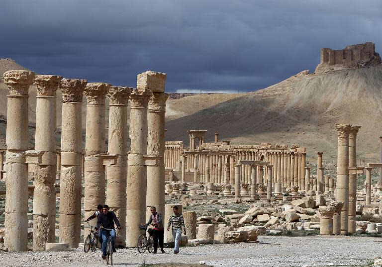 Syrian citizens riding their bicycles in the ancient oasis city of Palmyra, on March 14, 2014