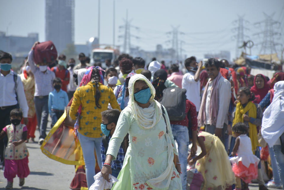 GHAZIABAD, INDIA - MARCH 29: Migrant workers head home on Day 5 of the 21 day nationwide lockdown imposed by PM Narendra Modi to curb the spread of coronavirus, at NH9 road, near Vijay Nagar, on March 29, 2020 in Ghaziabad, India. (Photo by Sakib Ali/Hindustan Times via Getty Images)