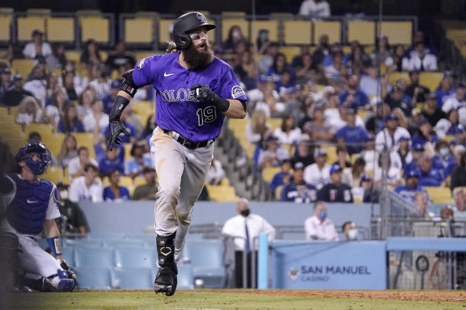 Colorado Rockies' Charlie Blackmon runs to first after hitting a two-run home run as Los Angeles Dodgers catcher Will Smith kneels at the plate during the 10th inning of a baseball game Friday, July 23, 2021, in Los Angeles. (AP Photo/Mark J. Terrill)