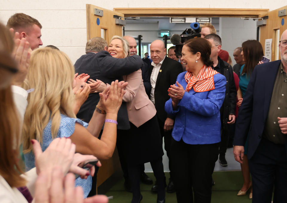 Sinn Fein's Michelle O'Neill, left, and party leader Mary Lou McDonald are greeted by supporters as they arrive at Medow Bank election count centre on Saturday, May, 7, 2022, in Magherafelt , Northern Ireland. (AP Photo/Peter Morrison)