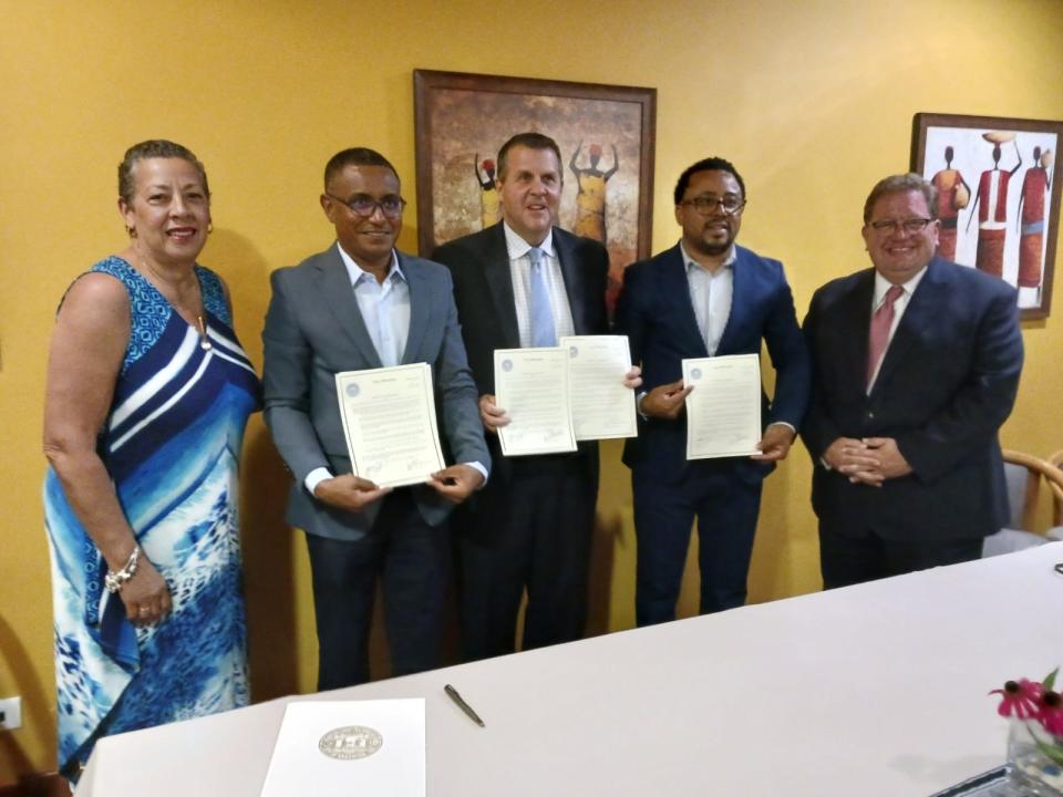 Showing off signed copies of sister cities agreements are, from left, Brockton Chief of Staff Sydné Marrow; Mayor of São Filipe Nuias Mendes Barbosa Da Silva; Brockton Mayor Robert Sullivan; Mayor of Mosteiros Fabio Vieira and Brockton Chief Financial Officer Troy Clarkson during a visit to Cape Verde in December 2022.