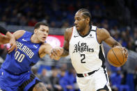 Los Angeles Clippers forward Kawhi Leonard (2) drives past Orlando Magic forward Aaron Gordon (00) during the first quarter of an NBA basketball game in Orlando, Fla., Sunday, Jan. 26, 2020. (AP Photo/Reinhold Matay)