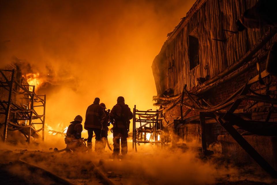 Firefighters work on the site of a fire in Kharkiv, Ukraine on May 4, 2024. According to the Head of the local regional administration, Oleh Syniehubov, the Russian army attacked the city with kamikaze drones at night. The attack caused a fire at a service station and injured three people, including a 13-year-old girl and an elderly woman. (Viacheslav Mavrychev/Suspilne Ukraine/JSC "UA:PBC"/Global Images Ukraine via Getty Images)