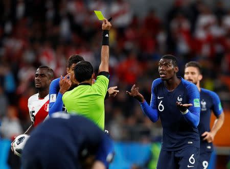 Soccer Football - World Cup - Group C - France vs Peru - Ekaterinburg Arena, Yekaterinburg, Russia - June 21, 2018 France's Paul Pogba is shown a yellow card by referee Mohammed Abdulla Hassan Mohamed REUTERS/Jason Cairnduff