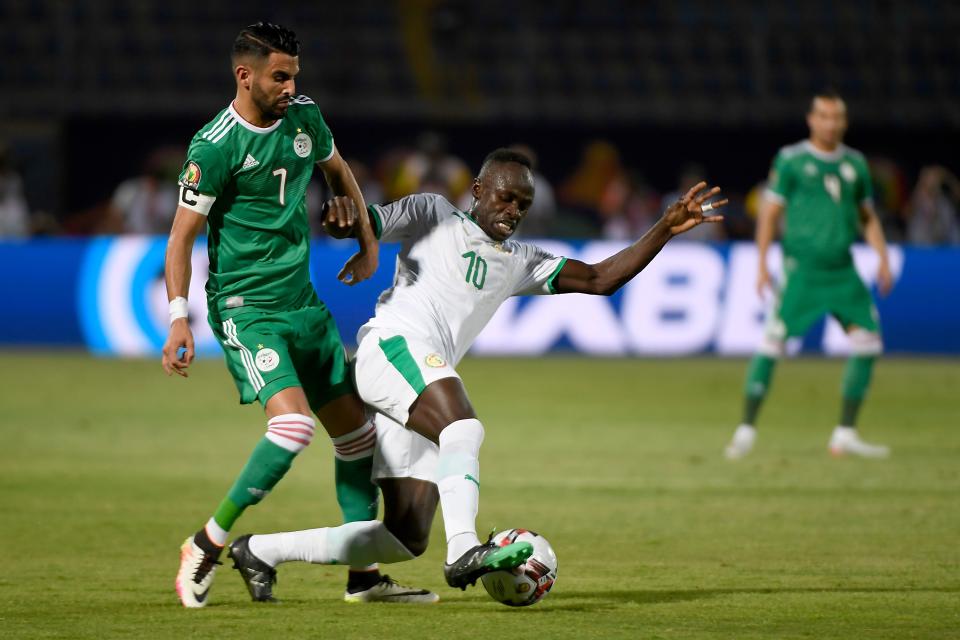 Algeria's forward Riyad Mahrez (L) fights for the ball with Senegal's forward Sadio Mane  during the 2019 Africa Cup of Nations (CAN) football match between Senegal and Algeria at the June 30 Stadium in Cairo on June 27, 2019. (Photo by Khaled DESOUKI / AFP)        (Photo credit should read KHALED DESOUKI/AFP/Getty Images)