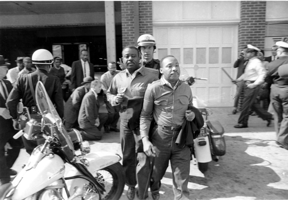 In this file photo taken April 12, 1963 Rev. Ralph Abernathy, left, and Rev. Martin Luther King Jr., right are taken by a policeman as they led a line of demonstrators into the business section of Birmingham, Ala. Arrested for leading a march against racial segregation in 1963, King Jr. spent days in solitary confinement writing his "Letter From Birmingham Jail," which was smuggled out and stirred the world by explaining why Black people couldn't keep waiting for fair treatment.