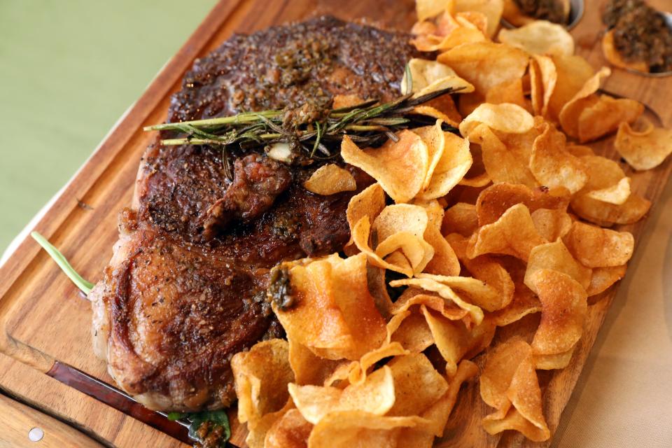 The Bistecca, grilled ribeye with Argentinean chimichurri sauce and housemade potato chips, at Piccola Trattoria in Dobbs Ferry. Photographed Sept. 20, 2023.