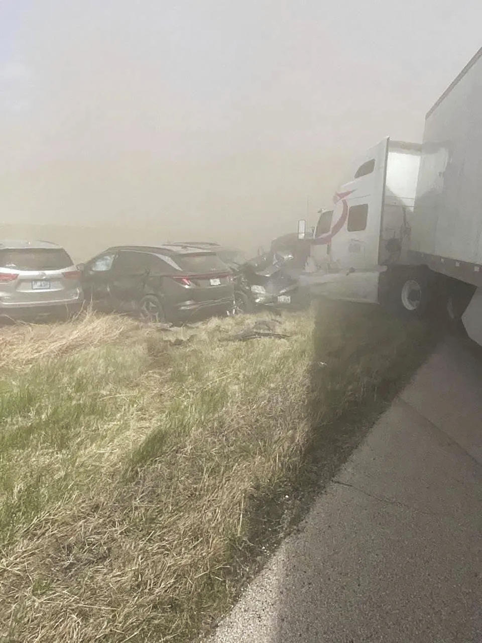 A crash involving at least 20 vehicles shut down a highway in Illinois, Monday, May 1, 2023. Illinois State Police say a windstorm that kicked up clouds of dust in south-central Illinois led to numerous crashes and multiple fatalities on Interstate 55. (WICS TV via AP)