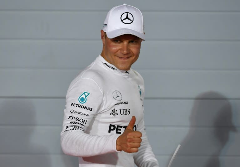 Mercedes' Finnish driver Valtteri Bottas celebrates after taking the pole position at the end of the qualifying for the Bahrain Formula One Grand Prix at the Sakhir circuit in Manama on April 15, 2017