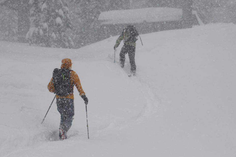 People ski during a blizzard Sunday, March 3, 2024, in Olympic Valley, Calif. (AP Photo/Brooke Hess-Homeier)