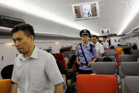 A Chinese policeman patrols a train during the first day of service of the Hong Kong Section of the Guangzhou-Shenzhen-Hong Kong Express Rail Link, in Hong Kong, China September 23, 2018. REUTERS/Tyrone Siu