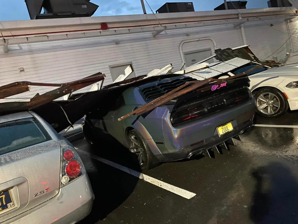 A tornado damaged cars and blew down trees outside the Harvest Seasonal Grill at the Village at Newtown on Saturday night. The National Weather Service confirmed an EF1 tornado blew cut a four mile path through Newtown Township and Borough on Saturday evening