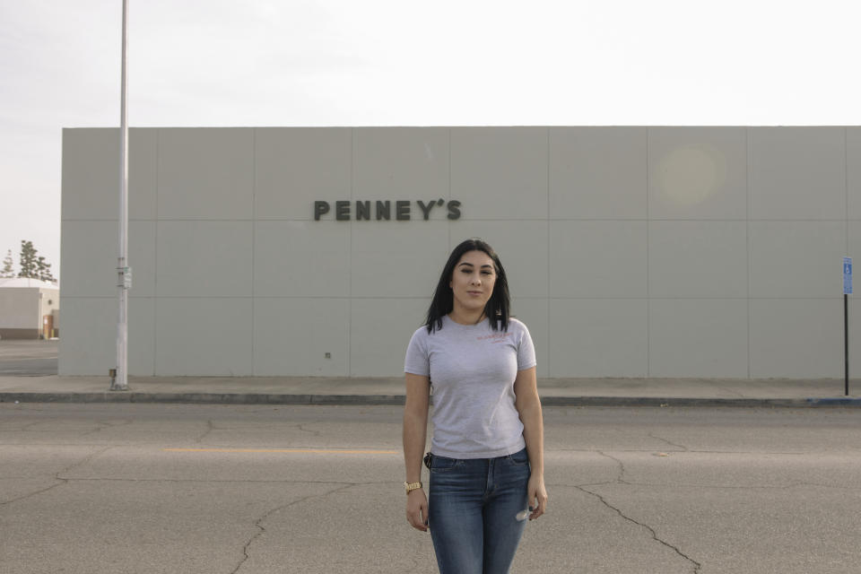 Alexandra Orozco stands for a portrait outside of the closed J.C. Penney, where she used to work, in Delano, Calif., on Sunday, Dec. 6, 2020. The 118-year-old department store chain filed for bankruptcy in May. (Madeline Tolle/The Fuller Project via AP)