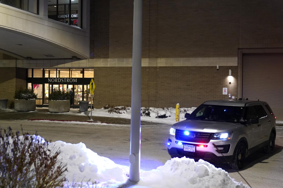 A police car sits parked outside Nordstrom at Mall of America after a shooting Friday, Dec. 23, 2022, in Bloomington, Minn. (AP Photo/Abbie Parr)