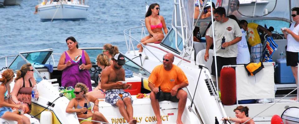 NEWPORT, RI__CIRCA_ AUGUST 5, 2011.__People on yachts and boats watching the Newport Jazz Festival from the lake.