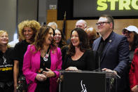 SAG-AFTRA President Fran Drescher, center with National Executive Director and Chief Negotiator Duncan Crabtree-Ireland, right, joined by the TV/Theatrical Negotiating Committee members celebrate after a news conference at the SAG-AFTRA offices in Los Angeles on Friday, Nov. 10, 2023. (AP Photo/Richard Vogel)