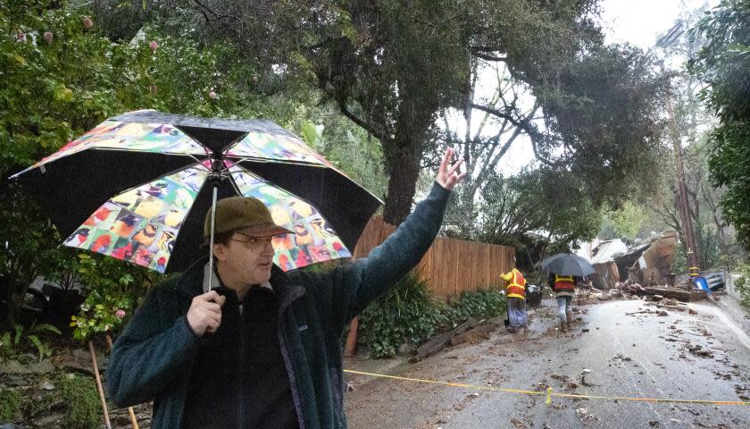 Los Angeles, CA - February 05: Caribou Lane Resident Travis Longcore said he and neighbors evacuated themselves after hearing a loud rumbling sound around 2 a.m. when a Beverly Crest home was pushed off its foundation by a mudslide early Monday morning on Caribou Lane near Beverly Glen Boulevard. No one was home when the mudslide occurred. The debris completely covers Caribou Lane and caused extensive damage to several others. Rocks, plywood and a piano were washed out of the home and a piano, visible at right, was turned upside down on the street. An atmospheric river unleashed heavy rain in Southern California Monday, Feb. 5, 2024. (Allen J. Schaben / Los Angeles Times)