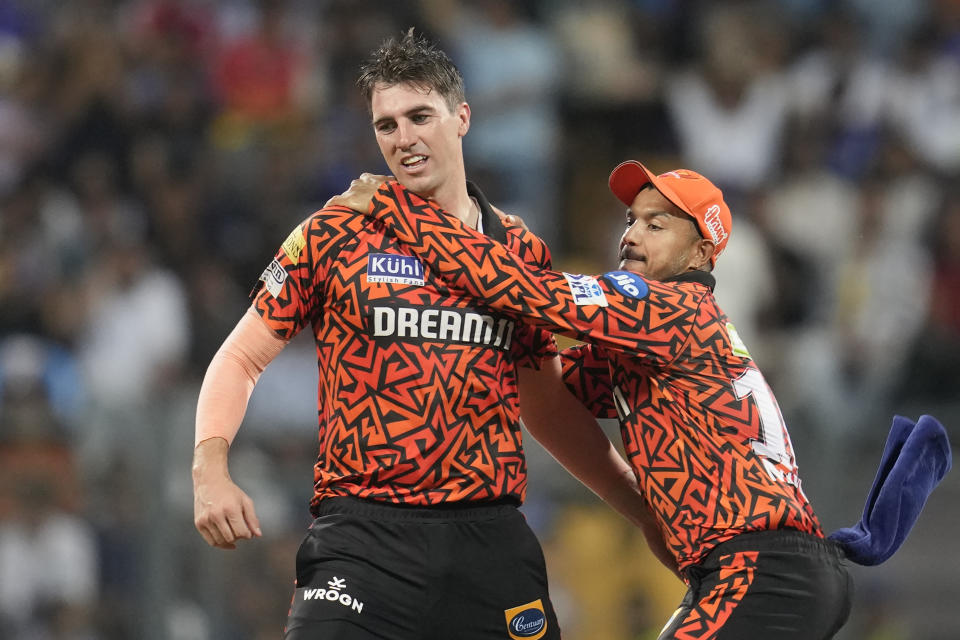 Sunrisers Hyderabad's captain Pat Cummins, left, celebrates the wicket of Mumbai Indians' Rohit Sharma with teammate during the Indian Premier League cricket match between Mumbai Indians and Sunrisers Hyderabad in Mumbai, India, Monday, May 6, 2024. (AP Photo/Rajanish Kakade)