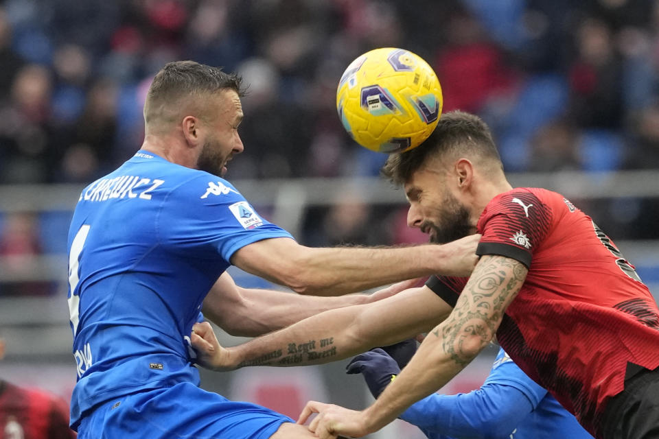 AC Milan's Olivier Giroud, right, jumps for the ball with Empoli's Sebastian Walukiewicz during a Serie A soccer match between AC Milan and Empoli at the San Siro stadium in Milan, Italy, Sunday, March 10, 2024. (AP Photo/Luca Bruno)