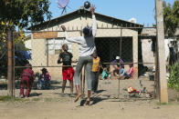 Children play with a ball outside a house, in Harare, Friday, July, 31, 2020. Zimbabwe's capital, Harare, was deserted Friday, as security agents vigorously enforced the country's lockdown amidst planned protests. Police and soldiers manned checkpoints and ordered people seeking to get into the city for work and other chores to return home. (AP Photo/Tsvangirayi Mukwazhi)