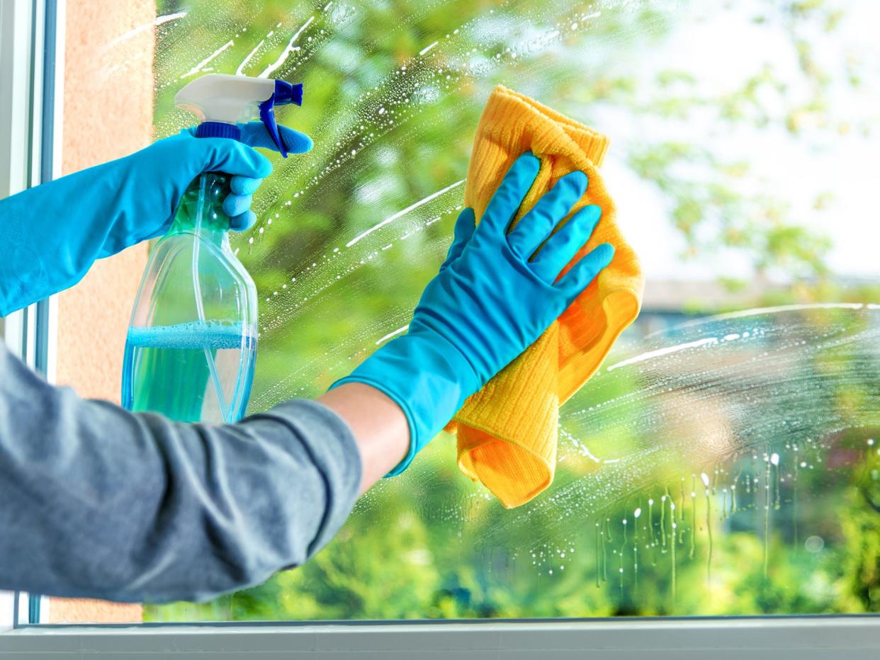 Cleaning window pane with detergent, spring cleaning concept