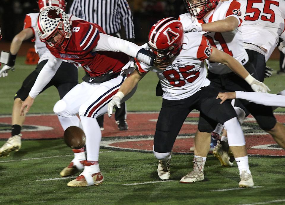 West Central's Mason Carnes (8) battles for the fumble by Amboy's Brennan Blaine (85) in the Illinois 8-player championship Friday in Monmouth, Illinois. West Central would recover the fumble.