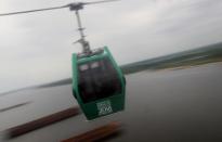 Visitors take a cable car ride over the River Volga between Bor and Nizhny Novgorod, Russia July 1, 2018. REUTERS/Darren Staples