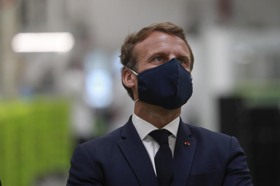 FILE - In this Tuesday, May 26, 2020 file photo, French President Emmanuel Macron wears a face mask as he visits the Valeo manufacturer plant, in Etaples, northern France. European Union leaders will meet face-to-face on Friday, July 17, 2020 for their summit as they try to carve up a potential package of 1.85 trillion euros among themselves. In perhaps the first such major meeting of leaders since the COVID-19 outbreak hit the world, the stakes were just too high for attendees not to look one another in the eye. (Ludovic Marin, Pool via AP, File)