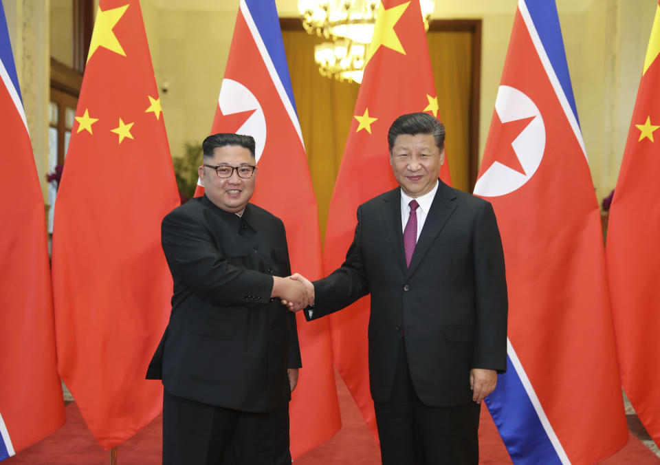 FILE- In this June 19, 2018, file photo provided by China's Xinhua News Agency, Chinese President Xi Jinping, right, shakes hands with North Korean leader Kim Jong Un, during a welcome ceremony at the Great Hall of the People in Beijing. This week’s meeting between visiting Chinese President Xi Jinping and North Korean leader Kim Jong Un in Pyongyang follows hard efforts to normalize relations that had deteriorated for years while Kim aggressively pursued nuclear weapons and brutally purged members of the North Korean old guard with close ties to Beijing. (Ju Peng/Xinhua via AP, File)