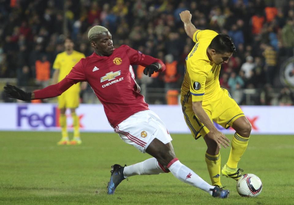 <p>Manchester United’s Paul Pogba, left, and Rostov’s Christian Noboa fight for the ball </p>