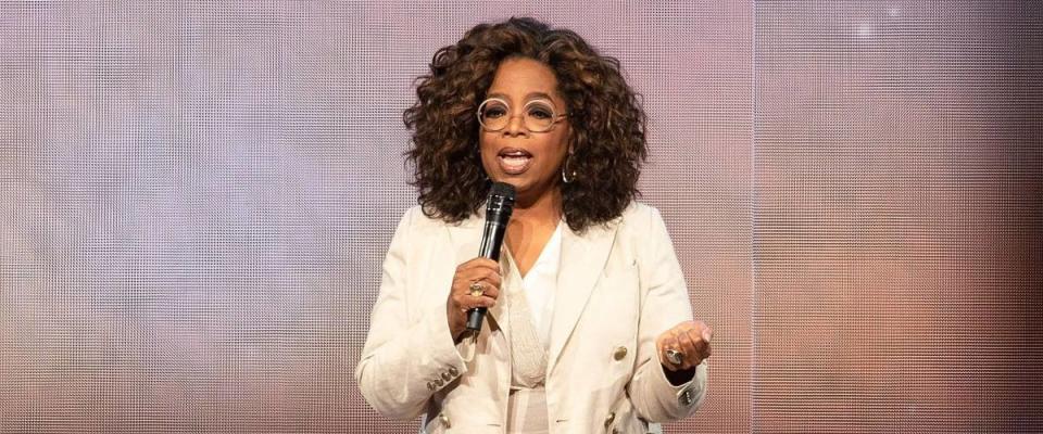 Oprah Winfrey on stage talking into microphone