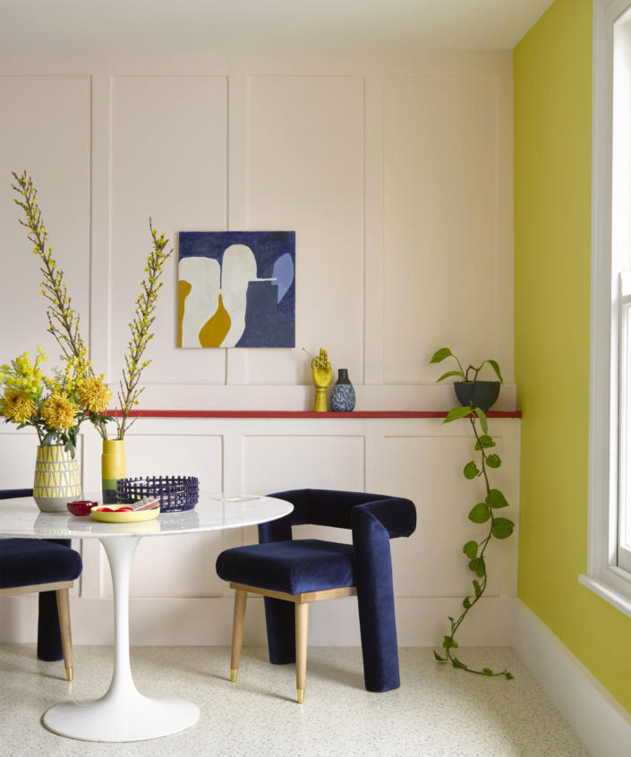 <p> Whether you want to create an element of contrast or elevate an accent color for your dining room paint ideas, painting a feature wall can make a colorful, eye-catching statement.&#xA0; </p> <p> In this dining room, painted in shades Soft Pink, Chilli Pepper and Yellow Finch by Benjamin Moore, within this beautiful mix of colors, the bright yellow creates an uplifting and playful feature wall, and establishes an elegant contrast with the blue upholstery and decorative accent pieces, great for yellow dining rooms. </p> <p> With the help and knowledge of the color wheel, you can create unique, painted color combinations for your dining room to make it a show stopping space. </p>