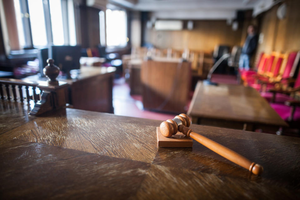 Color image of a hammer in a courtroom.