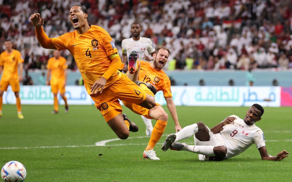 Mohammed Muntari of Qatar fouls Virgil Van Dijk of Netherlands - Catherine Ivill/Getty Images