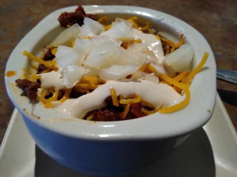 The smoked chili at Great Oaks Tavern is topped with cheddar cheese, onions and sriracha lime sour cream.