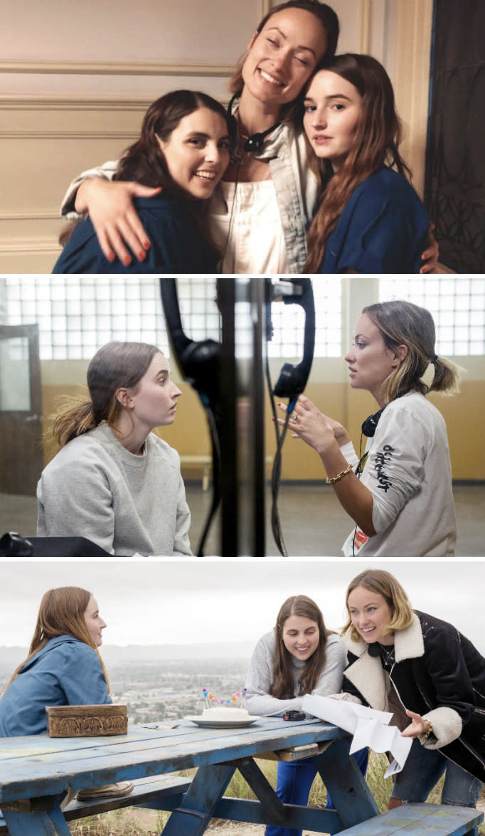 Wilde posing with Beanie Feldstein and Kaitlyn Dever behind the scenes of "Booksmart;" Wilde directing Dever in jail;" Wilde directing Feldstein and Dever at a park bench