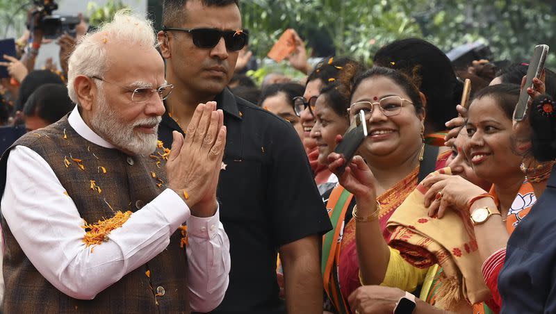 Indian Prime Minister Narendra Modi is welcomed at the Bharatiya Janata Party headquarters, where he was honored a day after the women’s reservation bill was passed by the Indian Parliament in New Delhi on Friday, Sep. 22, 2023.