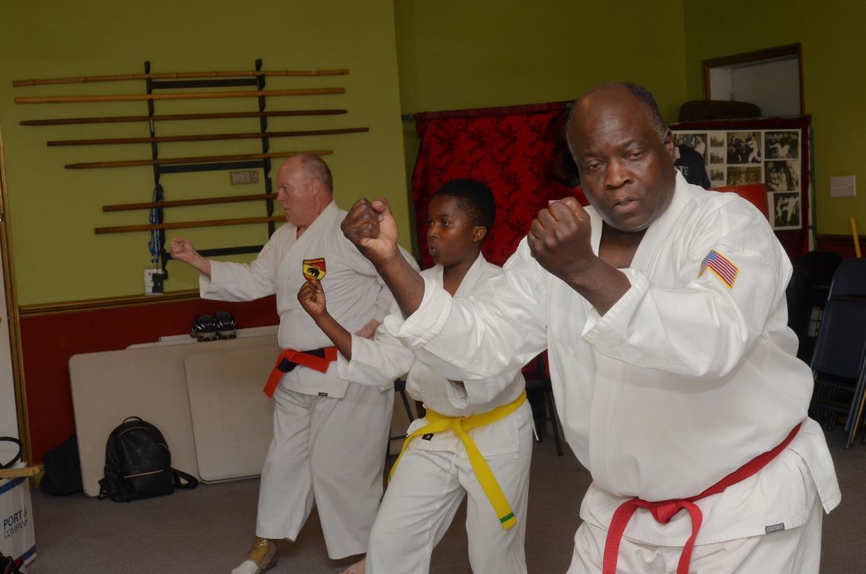 Chief Instructor Ronnie Lovick and Sensei David Harris practice kata, a form of martial arts movements, with student Brandon Forbes at the New Bern School of Martial Arts. Like many students at the school, Forbes said the training has helped him deal with threats from bullies and other problems.
