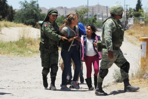 Mexican National Guard soldiers detain Central American migrants trying to cross the Rio Grande into the United States at Ciudad Juarez