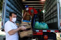 Former Brazil's head soccer coach Dunga helps with food distribution to poor people, amid the coronavirus disease (COVID-19) outbreak, in Porto Alegre