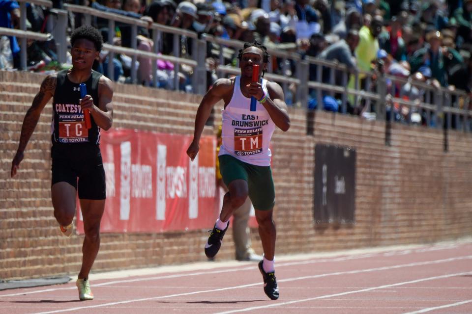 East Brunswick's Aiden Baldelli, right, competes in a 4x100 heat Friday, April 29, 2022 at the Penn Relays in Philadelphia, Pa.